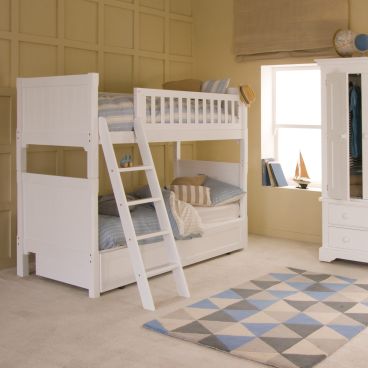 White premium traditional Fargo luxury bunk bed with pitched ladder and trundle underneath, with wardrobe and travel theme accessories