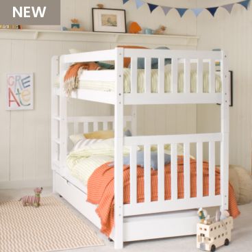Bunk bed with trundle tucked underneath in gender neutral bedroom with blue, orange and green accessories.