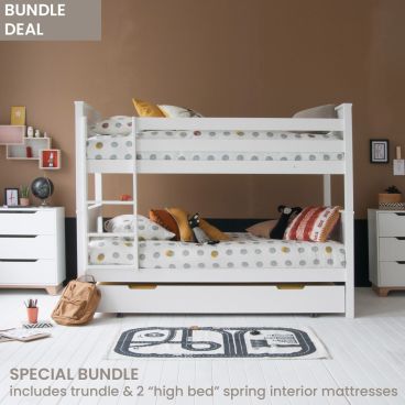 White classic beech bunk bed with trundle underneath, chest of drawers and spot bedding, against brown and black wall.