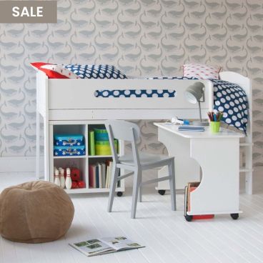 mid sleeper white bed with rolled out desk and storage cube bookcase, with grey whale wallpaper behind