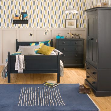 child's navy bed, chest of drawers, wardrobe straight on to camera in blue and yellow bedroom