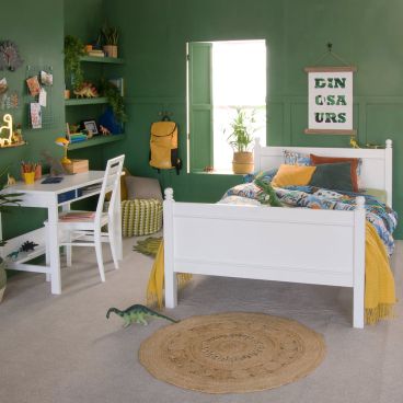 green bedroom with white small double bed for kids and desk and chair 