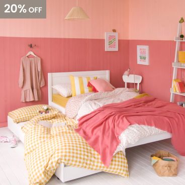 white small double bed with trundle pulled out and ready for sleepover