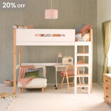 A two tone beech and white loft high sleeper bed with a futon chair, desk and study chair underneath. There are green panelled walls, a green curtain hanging at the window and a pink ceiling lampshade 
