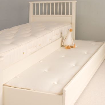 Close up photo of high bed traditional open coil mattress on a high bed