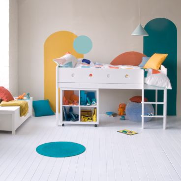 geometric colourful wall mural, child's bedroom with white mid sleeper bed and storage 