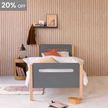 natural and anthracite two tone children's bed with curved corners and pill shape cut outs in the head and foot boards in modern room with wood effect wallpaper