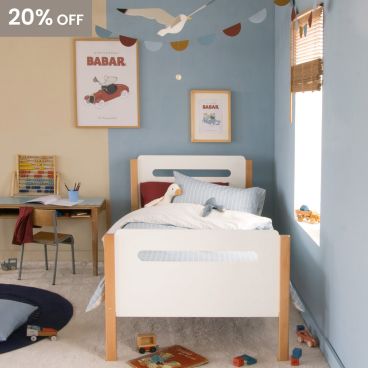 blue and beige themed bedroom with seagulls, retro style, for boys. Curved bed with blue striped bedding and seagulls 