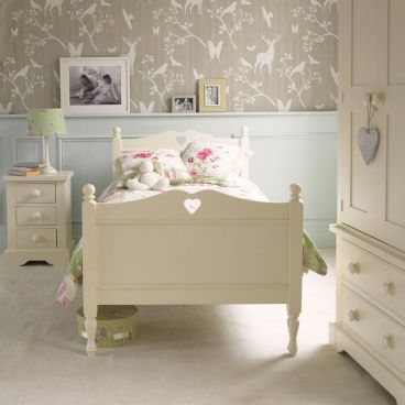 Pretty girls single bed with carved heart, bedside table with three drawers and wardrobe