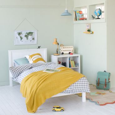 Classic white childrens bed with low end in boys bedroom with animal theme