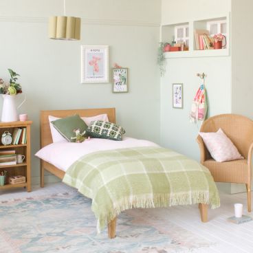 Modern Oak Linus single bed in green and pink girls bedroom with green blanket 