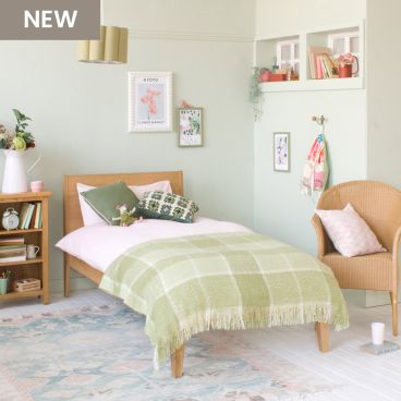 Modern Oak Linus single bed in green and pink girls bedroom with green blanket 
