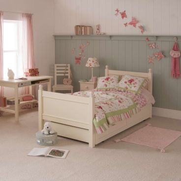 Luxury classic single bed with trundle for kids, ivory white, in girls bedroom shown with study desk and matching chair