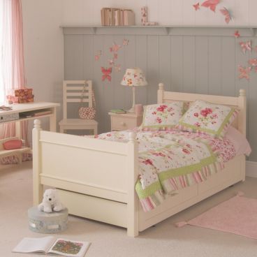 Luxury classic single bed with trundle for kids, ivory white, in girls bedroom shown with study desk and matching chair