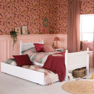 White single bed with trundle pulled out as a sleepover bed with matching bedding