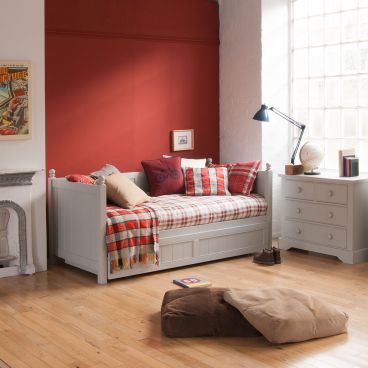 Boy's traditional bed in red+grey tartan room. fireplace, day bed and chest of drawers