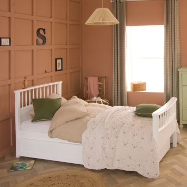 white single Bowood bed with spindles on the ends, green cushions and terracotta walls 
