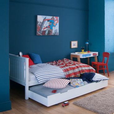 kids white single bed with sleepover trundle in blue + red room