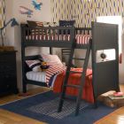 Traditional dark blue boys bunk bed, with red and blue bedding and geometric wallpaper 