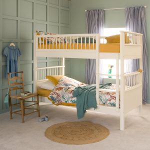 ivory white spindle Bowood bunk bed with fitted ladder, in child's bedroom with vintage chair and striped curtains 