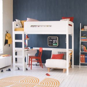 white high sleeper bed with lozenge cut out, roll out desk and futon underneath, in blue panelled older child's bedroom with mid century styled accessories and ladder shelf.