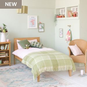 Modern Oak Linus single bed in green and pink girls bedroom with green blanket 