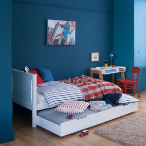 kids white single bed with sleepover trundle in blue + red room
