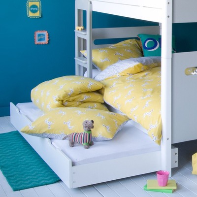 bunk bed with trundle pulled out and duvet set rolled up