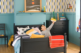 blue walls, navy blue bed, space themed room 