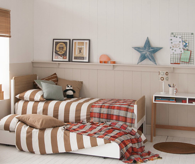 childs bed with striped duvet cover and trundle 