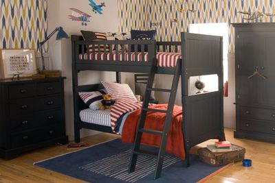 Dark blue bunk bed, chest of drawers and wardrobe in traditional boys bedroom 