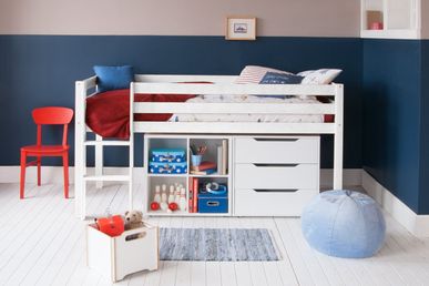 white mid sleeper bed, red retro chair, navy blue walls 