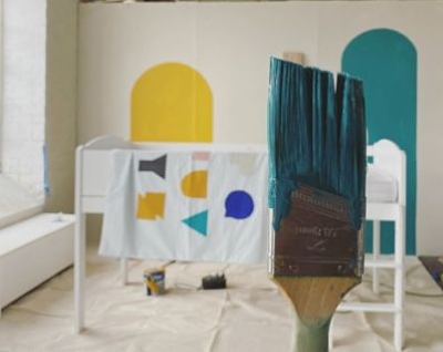 DIY mural behind the scenes yellow and teal arches and paintbrush