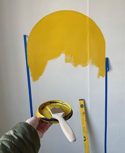 yellow painted DIY arch mural